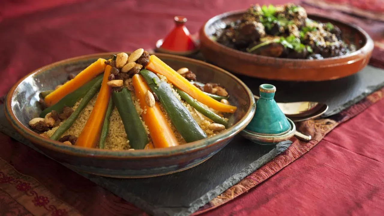 A traditional African meal of vegetable couscous and meat and prune tagine garnished with fresh coriander and sesame seeds. (Getty Images)