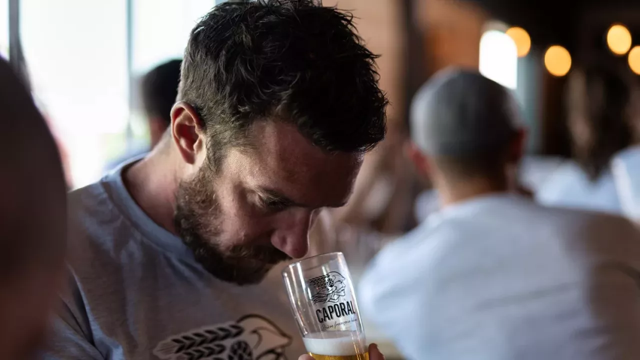 Person smelling glass of beer