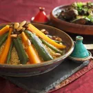 A traditional African meal of vegetable couscous and meat and prune tagine garnished with fresh coriander and sesame seeds. (Getty Images)