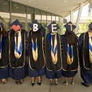 A group of graduating students with caps spelling out “We ❤️ Betty"