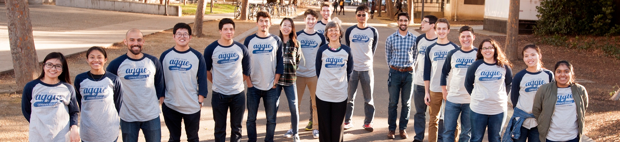 faculty and students posing in branded t-shirts